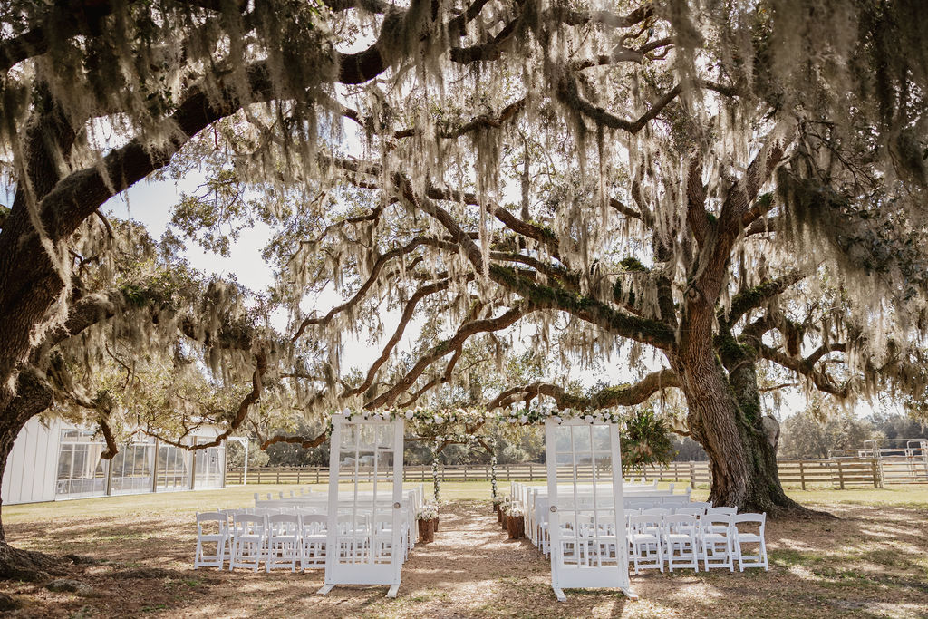 Outdoor ceremony site under the large oak trees waiting for the guests to arrive. Heart D Farm Wedding Venue.