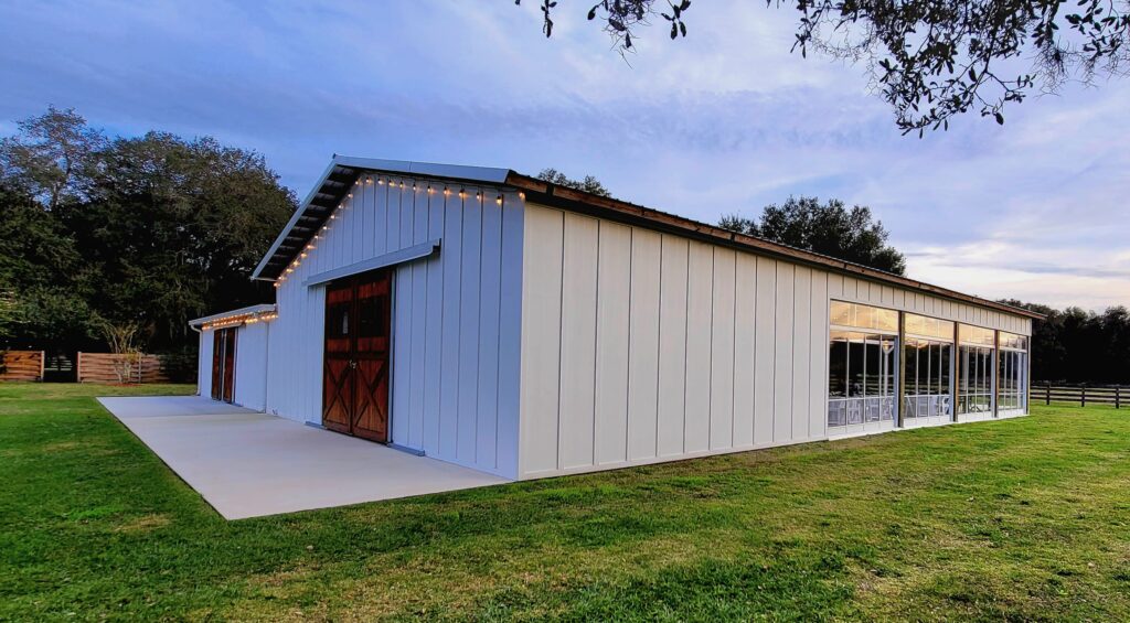 Our Big Barn Pavilion is solid white on the front and partially on the side.  We have two sets of stained cedar wood barn doors on the front.  The sides are also enclosed with our moving clear enclosure which is actually sliding clear vinyl doors for unobstructed views of open pastures.