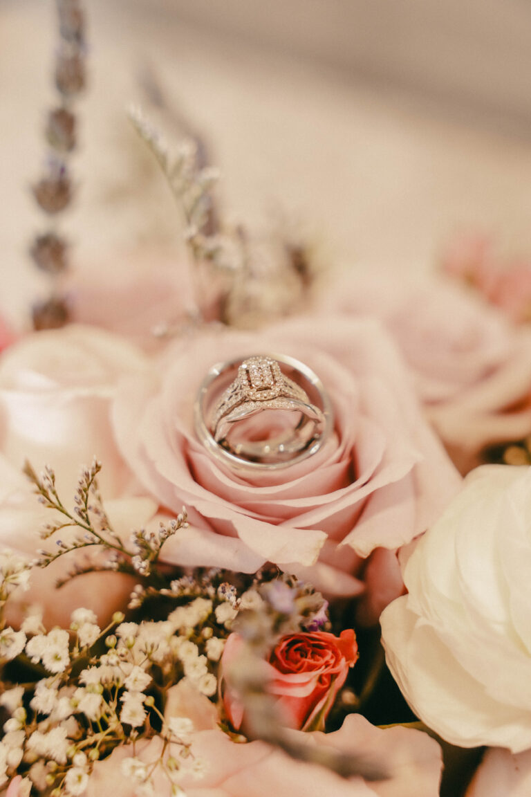 Wedding rings on a bouquet of flowers before the ceremony.